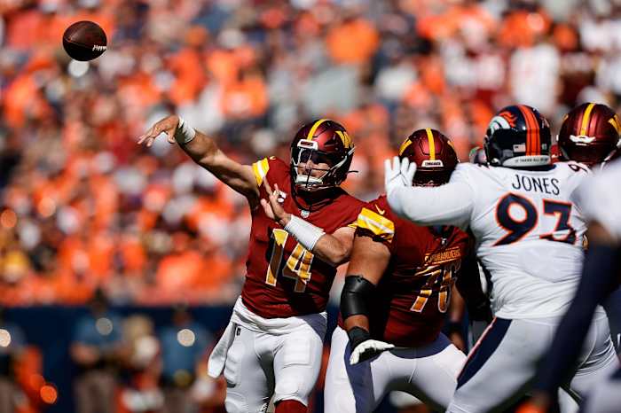Sep 17, 2023; Denver, Colorado, USA; Washington Commanders quarterback Sam Howell (14) attempts a pass as offensive tackle Sam Cosmi (76) defends against Denver Broncos defensive tackle D.J. Jones (93) in the first quarter at Empower Field at Mile High. Mandatory Credit: Isaiah J. Downing-USA TODAY Sports  